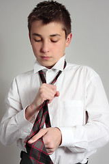 Image showing Boy getting dressed for school