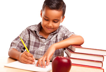 Image showing Adorable Hispanic Boy with Books, Apple, Pencil and Paper