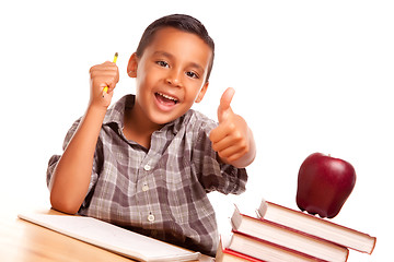 Image showing Adorable Hispanic Boy with Books, Apple, Pencil and Paper