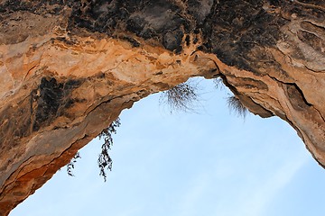 Image showing Stone arch of the cave exit on sky background 