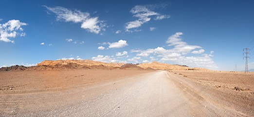 Image showing Road in the desert towards the distant rocks