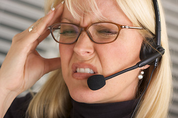 Image showing Businesswoman with Phone Headset and Headache