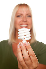 Image showing Attractive Blonde Woman Holds Energy Saving Light Bulb