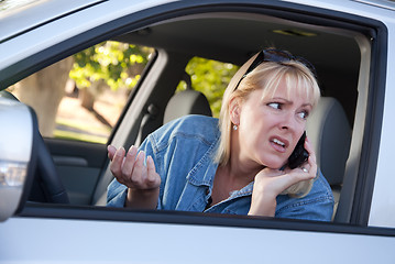 Image showing Concerned Woman Using Cell Phone While Driving