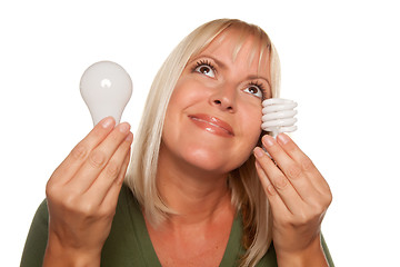 Image showing Smiling Woman Holds Energy Saving and Regular Light Bulbs