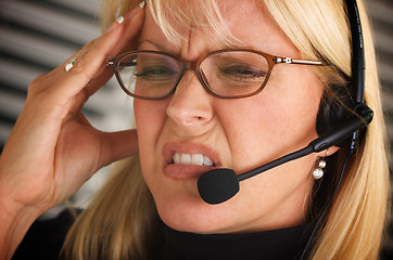 Image showing Businesswoman with Phone Headset and Headache