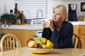 Image showing Woman in Kitchen with Cup of Coffee