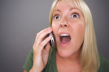 Image showing Stunned Blond Woman Using Cell Phone 