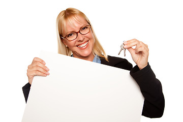 Image showing Attractive Blonde Holding Keys and Blank White Sign