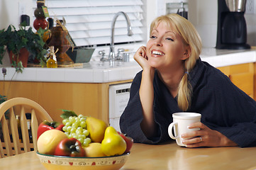Image showing Woman with Cup of Coffee in Kitchen Smiling