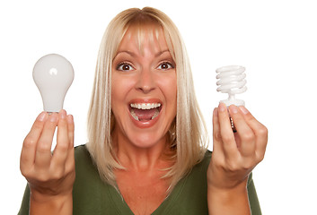 Image showing Woman Holds Energy Saving and Regular Light Bulbs