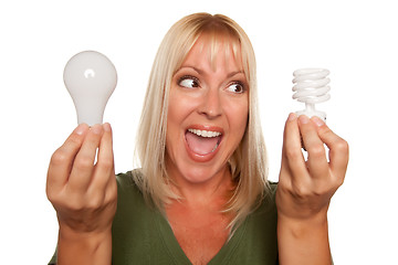 Image showing Woman Holds Energy Saving and Regular Light Bulbs