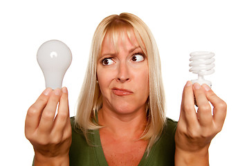 Image showing Funny Woman Holding Energy Saving and Regular Light Bulbs