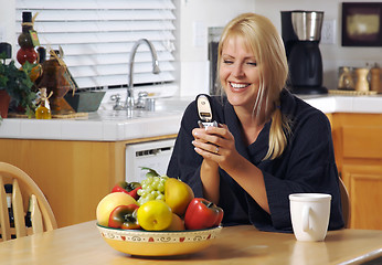 Image showing Woman In Kitchen Using Cell Phone