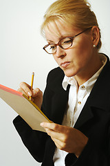 Image showing Beautiful Woman Thinks with Pencil & Notepad Taking Notes