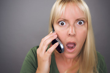 Image showing Stunned Blond Woman Using Cell Phone