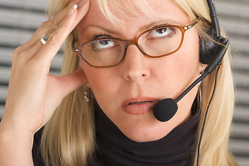 Image showing Businesswoman with Phone Headset and Headache