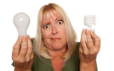 Image showing Funny Woman Holding Energy Saving and Regular Light Bulbs