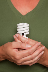 Image showing Female Hands Holding Energy Saving Light Bulb