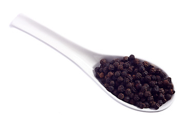 Image showing Black peppercorns on a spoon