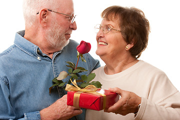 Image showing Happy Senior Couple with Gift and Red Rose