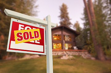 Image showing Sold Home For Sale Sign and Beautiful Log Cabin