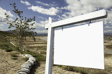 Image showing Blank Real Estate Sign and Empty Construction Lots