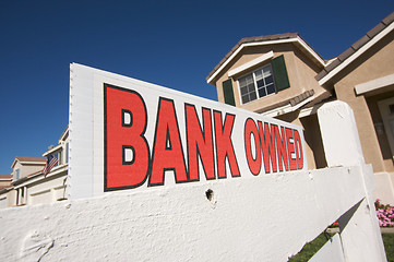 Image showing Bank Owned Real Estate Sign and House with American Flag