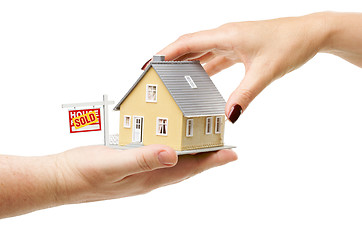 Image showing Reaching For A Home with Sold Real Estate Sign