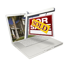 Image showing Sold Home for Sale Sign & New House Laptop