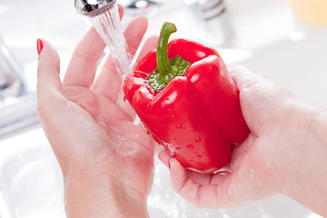 Image showing Woman Washing Red Bell Pepper