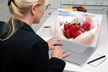 Image showing Woman In Kitchen Using Laptop - Food and Recipes