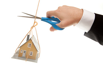 Image showing Hand with Scissors Cutting String Holding House 