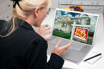 Image showing Excited Woman In Kitchen Using Laptop - Real Estate Success