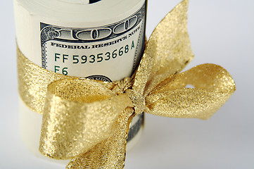 Image showing One Hundred Dollar Bills Wrapped in Gold Ribbon.