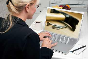 Image showing Woman In Kitchen Using Laptop - Home Improvement