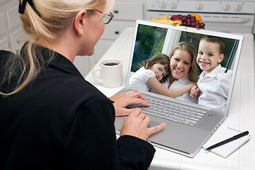 Image showing Woman In Kitchen Using Laptop - Family and Friends