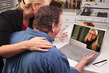 Image showing Couple In Kitchen Using Laptop - Customer Support