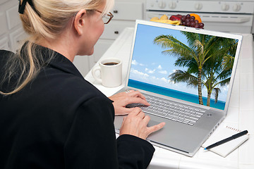 Image showing Woman In Kitchen Using Laptop - Vacation