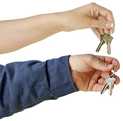 Image showing Man and Woman handing over house keys on a white background.