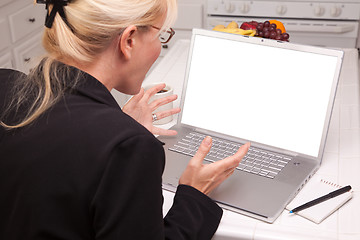 Image showing Excited Woman In Kitchen Using Laptop with Blank Screen