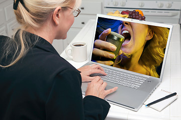 Image showing Woman In Kitchen Using Laptop - Entertainment