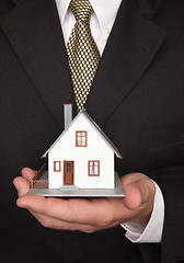 Image showing Businessman Holding House
