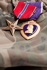 Image showing Bronze and Purple Heart Medals on Camouflage Material