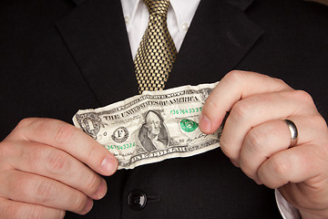 Image showing Businessman Holding Wrinkled Dollar Bill