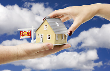 Image showing Reaching For A Home with Sold Real Estate Sign