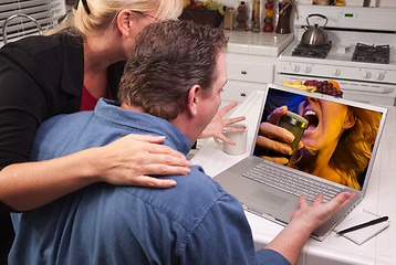 Image showing Couple In Kitchen Using Laptop - Music Entertainment