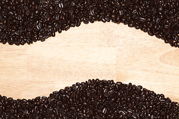 Image showing Dark Roasted Coffee Beans on Wood Background