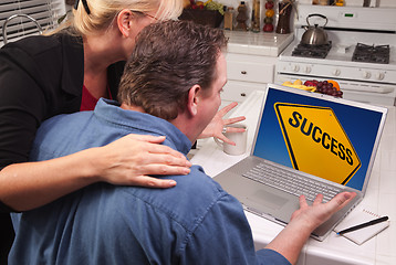 Image showing Couple In Kitchen Using Laptop - Success Sign