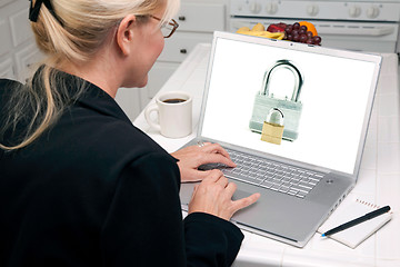 Image showing Woman In Kitchen Using Laptop - Security